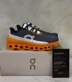 On Cloudmonster “Asphalt | Orange”